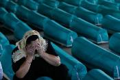 A woman froms Srebrenica mourns the death of one of up to 8,000 Bosnian Muslims who were killed in the massacre in July 1995.